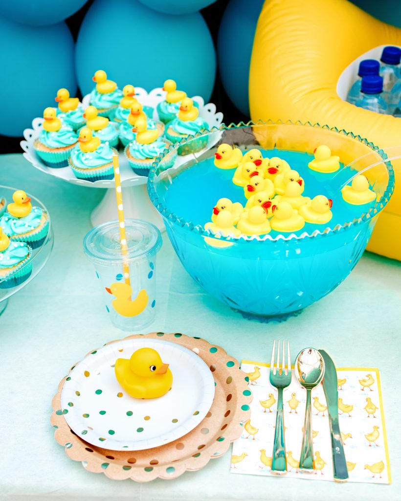 Rubber ducks floating in punch bowl and table settings
