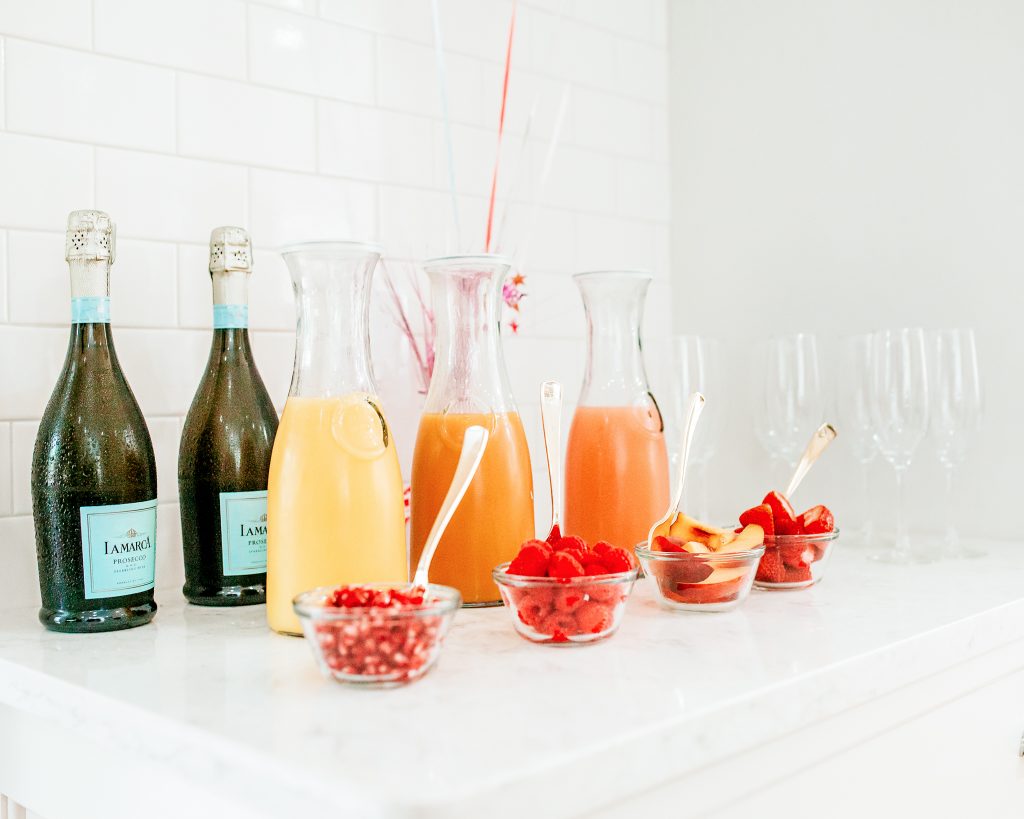 mimosa bar with juice and fresh fruit