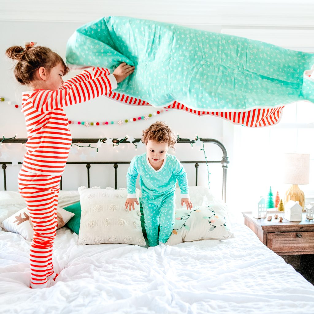 Children playing in holiday pajamas