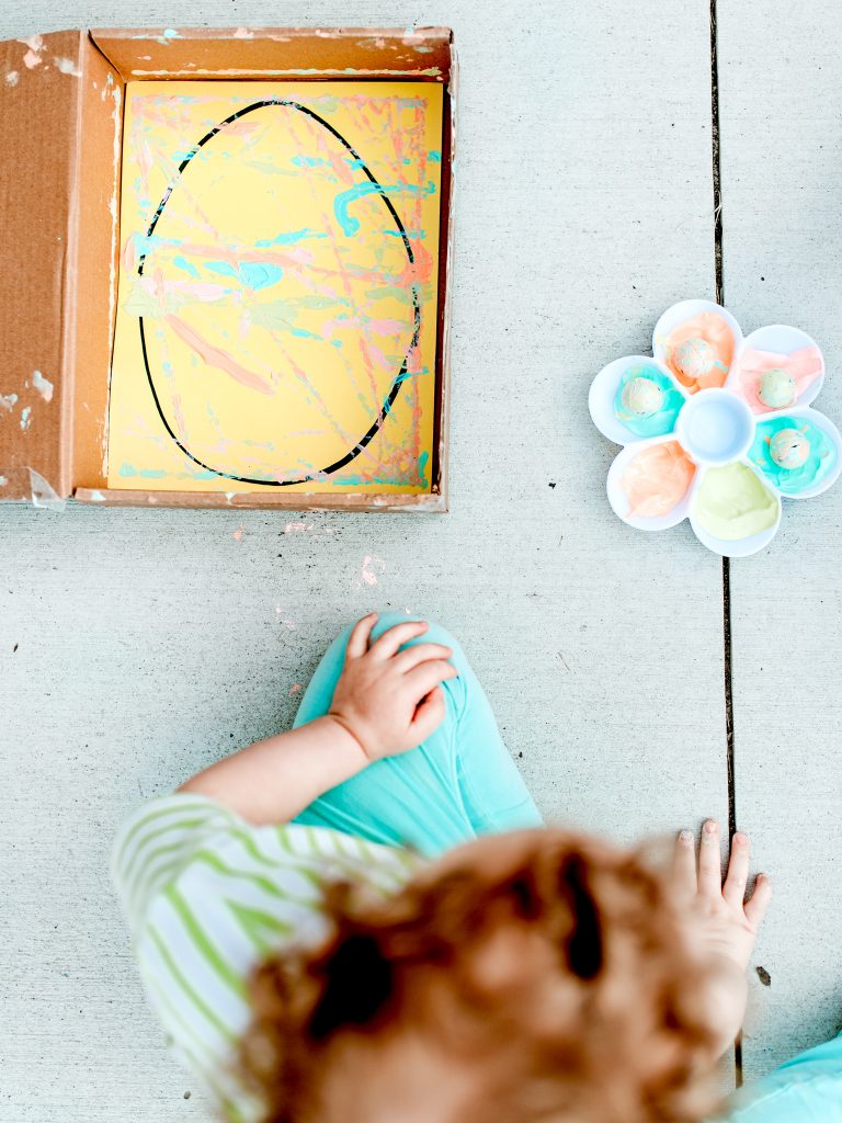 Make pretty Easter eggs by rolling painted marbles! 