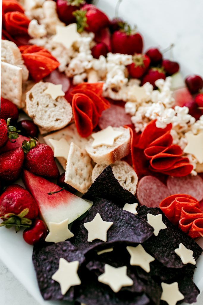 A red, white, and blue 4th of July charcuterie board. Put together an American Flag snack board for your next patriotic party!