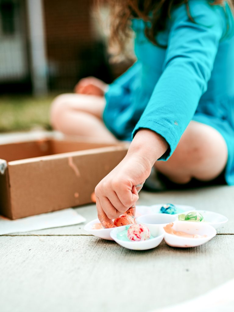 Use painted marbles to decorate paper Easter eggs 