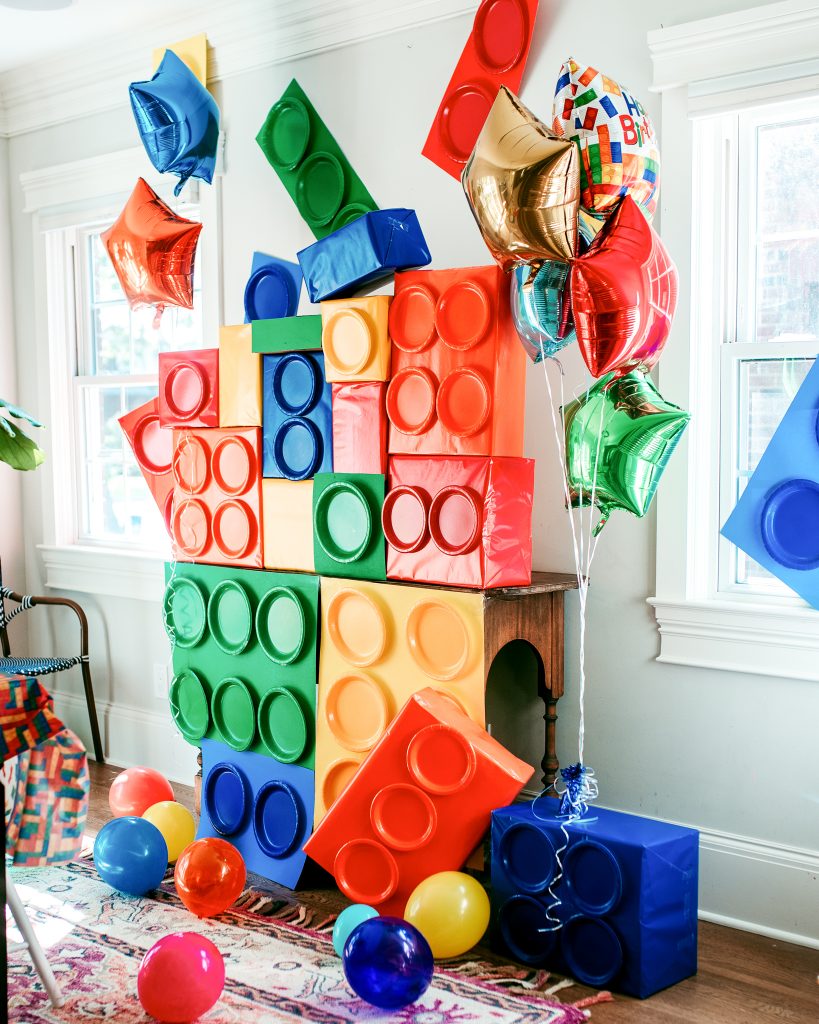 Lego birthday party DIY decorations! Use boxes, poster board, and paper plates to create giant legos!