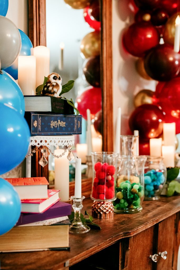 Hogwarts Harry Potter party decorations; use books, candles, and owls to create magical decor! More Harry Potter party ideas here!