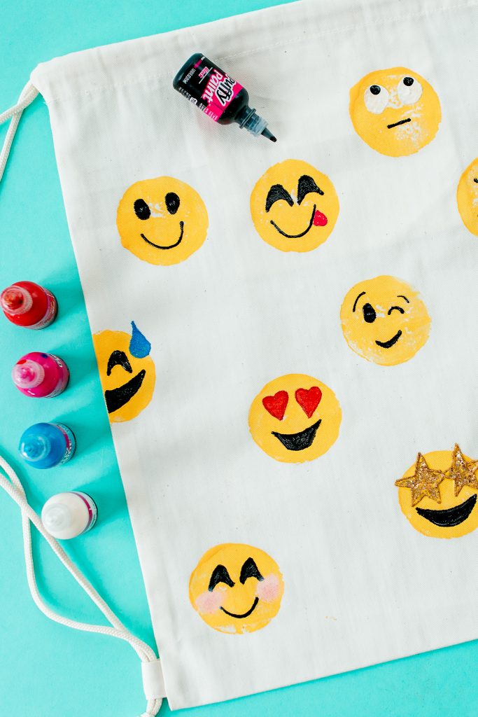 Follow these easy step-by-step instructions to design a fun DIY emoji print backpack using a potato stamp for Emoji Day (July 17)!