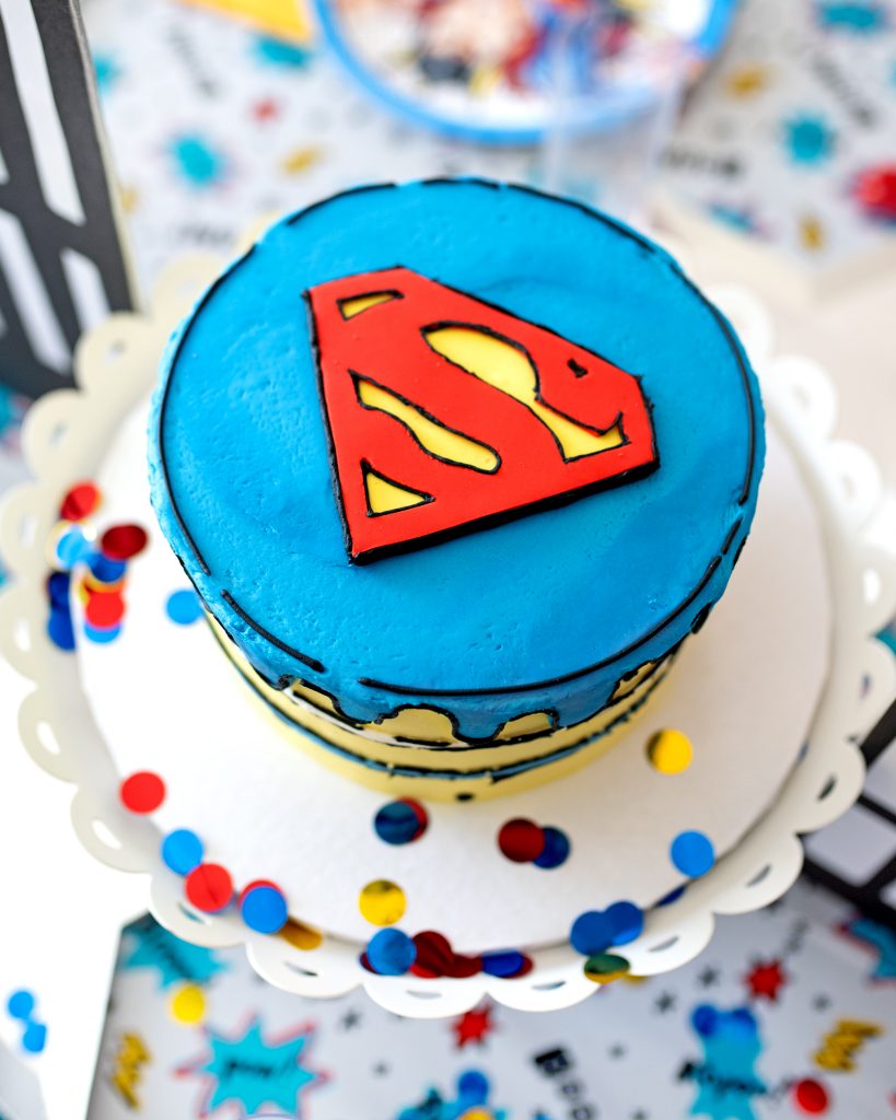 Celebrate with a Superman cake. Blue, yellow and red cake with Superman logo. 