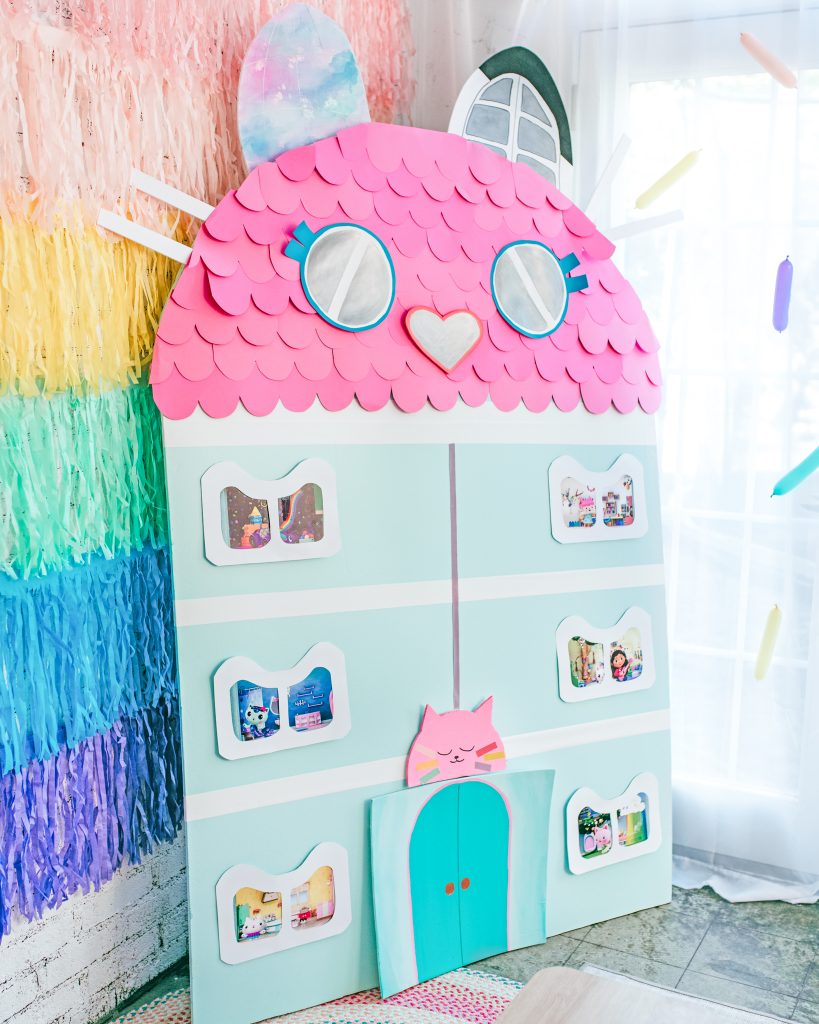 A DIY Gabby's Dollhouse backdrop decoration for a birthday party 