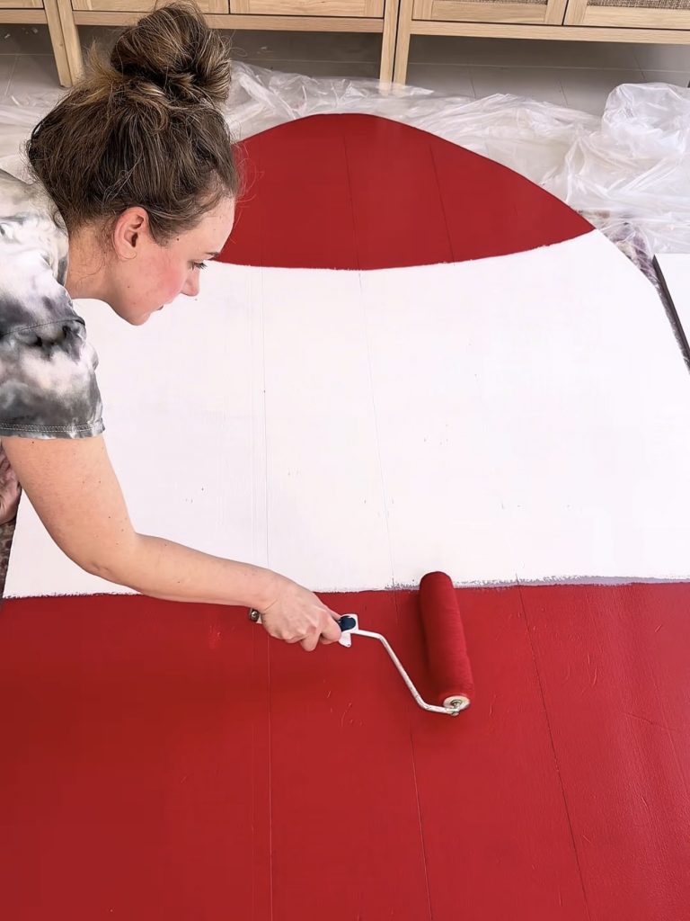 Painting a foam insulation board rocket display for a Toy Story birthday party decoration