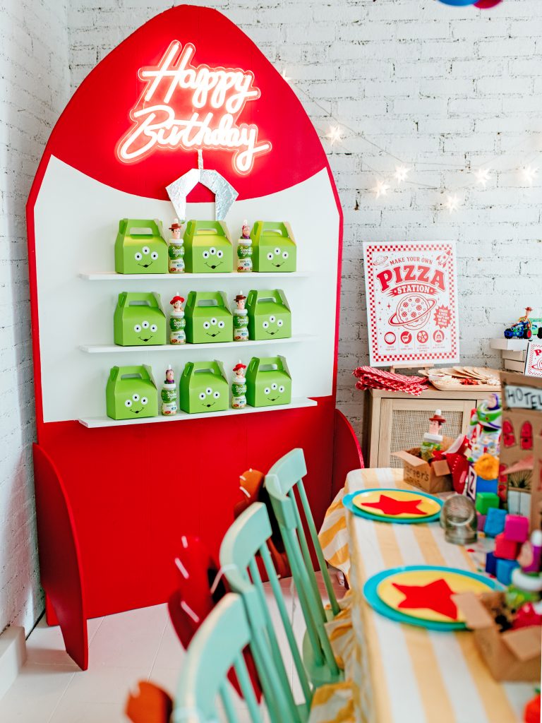 Rocket-shaped Claw DIY party favor wall made from foam insulation board for a Toy Story party